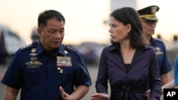 FILE - Philippine coast guard commandant Admiral Ronnie Gil Gavan speaks with German Foreign Minister Annalena Baerbock in Manila, Philippines, Jan. 11, 2024. Gavan said Nov. 7, 2024, the coast guard will acquire 40 patrol craft from France.