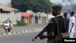 FILE - A member of security forces stands guard in the northern city of Kaduna, Nigeria, Oct. 4, 2018. Gunmen attacked villages in Kaduna and Katsina states on Feb. 24, 2021, leaving 36 people dead and several others injured.