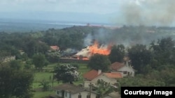 Le palais de Rwenzururu dans l'ouest de l'Ouganda incendié après l'arrestation du roi et de la reine, 27 novembre 2016.