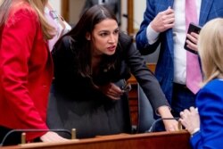 FILE - Rep. Alexandria Ocasio-Cortez, D-N.Y., speaks with other lawmakers during a break from testimony from Facebook CEO Mark Zuckerberg before a House Financial Services Committee hearing on Capitol Hill in Washington, Oct. 23, 2019.