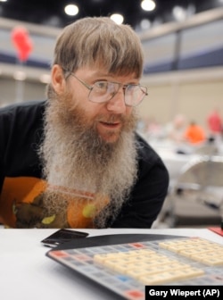 FILE - Scrabble world champion Nigel Richards looks across the board before the start of his final round, Wednesday, Aug. 13, 2014, at the National Scrabble Championships in Buffalo, N.Y. (AP Photo/Gary Wiepert, File)