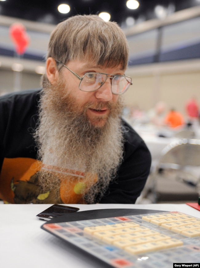 FILE - Scrabble world champion Nigel Richards looks across the board before the start of his final round, Wednesday, Aug. 13, 2014, at the National Scrabble Championships in Buffalo, N.Y. (AP Photo/Gary Wiepert, File)