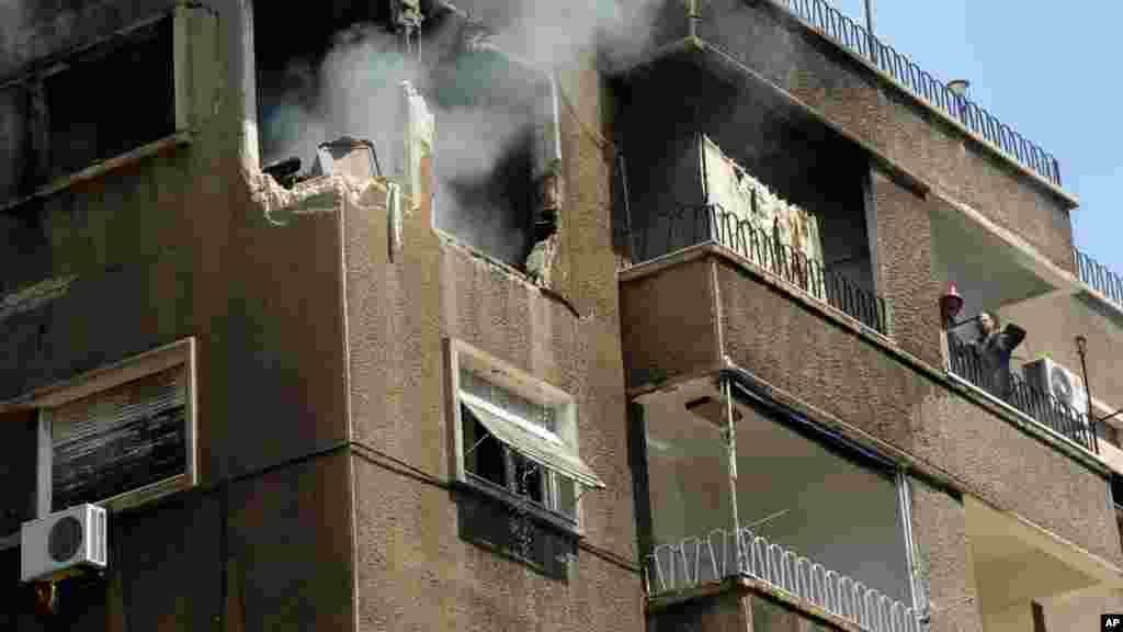 Syrian official news agency (SANA) photo shows a building damaged by what SANA said was a missile in Damascus, Sept. 2, 2013.