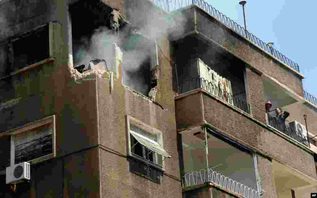 This photo released by the Syrian official news agency SANA shows a building damaged by what SANA said was a missile in Damascus, Sept. 2, 2013.