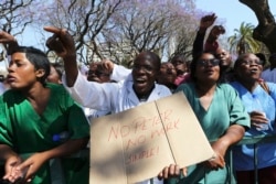 FILE - Zimbabwean medical staff march on the streets of Harare, Sept. 19, 2019.