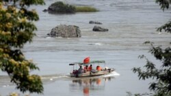 FILE - A Chinese boat with a team of geologists surveys the Mekong River, at the border between Laos and Thailand, April 23, 2017.