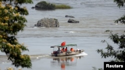 FILE - A Chinese boat with a team of geologists surveys the Mekong River, at the border between Laos and Thailand, April 23, 2017. 