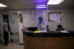 Palestinian doctors wear protective clothes as they work at the emergency room of the al-Quds Hospital in Gaza City, Sept. 7, 2020.