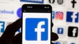 FILE - The Facebook logo is seen on a cell phone in Boston, USA, Friday, Oct. 14, 2022. (AP Photo/Michael Dwyer, File)