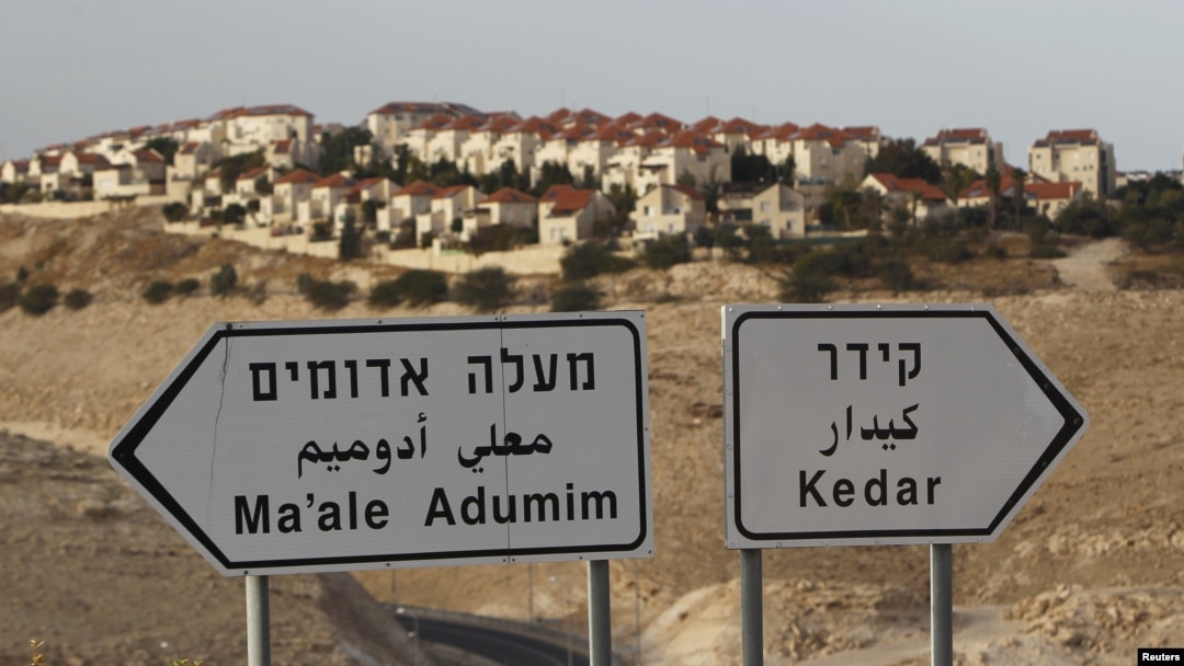 The West Bank Jewish settlement of Maale Adumim, near Jerusalem, is seen behind sign posts December 3, 2012. 