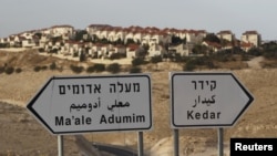 The West Bank Jewish settlement of Maale Adumim, near Jerusalem, is seen behind sign posts December 3, 2012. 