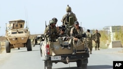 Afghan National Army soldiers arrive to start an operation, outside of Kunduz city, north of Kabul, Afghanistan, Sept. 30, 2015.