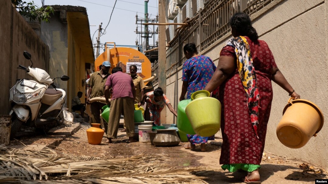 Residents arrive to fill their containers with drinking water from a tanker in a neighborhood that is facing severe water scarcity in Bengaluru, India, March 11, 2024. The U.N. marks World Water Day on March 22 and warns of the growing risk of conflict over scarce water.