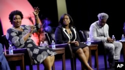 Stacey Abrams, left, house minority leader for the Georgia General Assembly, speaks on a panel discussion with Jotaka Eaddy, center, and Cornell Belcher, right, during the NAACP annual convention July 22, 2014, in Las Vegas.