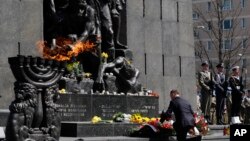 Polish President Andrzej Duda lays a wreath during state ceremonies in homage to the victims and fighters of the 1943 Warsaw Ghetto Uprising, on the 75th anniversary of the start of the revolt, in front of the Monument to the Warsaw Ghetto Heroes, in Wars