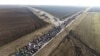 Students march trough the fields in northern Serbia as they protest over the collapse of a concrete canopy that killed 15 people more than two months ago, in Indjija, Serbia, Jan. 31, 2025. 