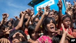 FILE - Rohingya refugee children shout slogans during a protest against the repatriation process at Unchiprang refugee camp near Cox's Bazar, in Bangladesh, Nov. 15, 2018.