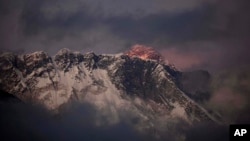 FILE - In this Oct. 27, 2011, photo, the last light of the day sets on Mount Everest as it rises behind Mount Nuptse as seen from Tengboche, in the Himalaya's Khumbu region, Nepal.