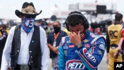 Driver Bubba Wallace, right, is overcome with emotion as he and team owner Richard Petty walk to his car prior to the start of the NASCAR Cup Series auto race at the Talladega Superspeedway in Talladega Ala., June 22, 2020. 