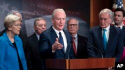 FILE - Sen. Chris Van Hollen, D-Md., center, is joined by fellow Democrats as they discuss a national security memorandum with the Biden administration at the Capitol in Washington, February 9, 2024.