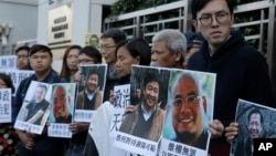 Pro-democracy activists hold pictures of Chinese activist Wu Gan (2nd-R) and other activists outside the Chinese central government's liaison office in Hong Kong, Dec. 27, 2017. 