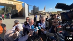 FILE - US Senator Chris Van Hollen (C-L) and US Senator Jeff Merkley (C-R) visit the Egyptian side of the Rafah border crossing with the southern Gaza Strip along with a US delegation on January 5, 2024.