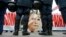 A banner with the portrait of jailed former prime minister Yulia Tymoshenko is seen as police stand guard during an opposition rally in front of the Parliament building in Kyiv, Nov. 13, 2013.