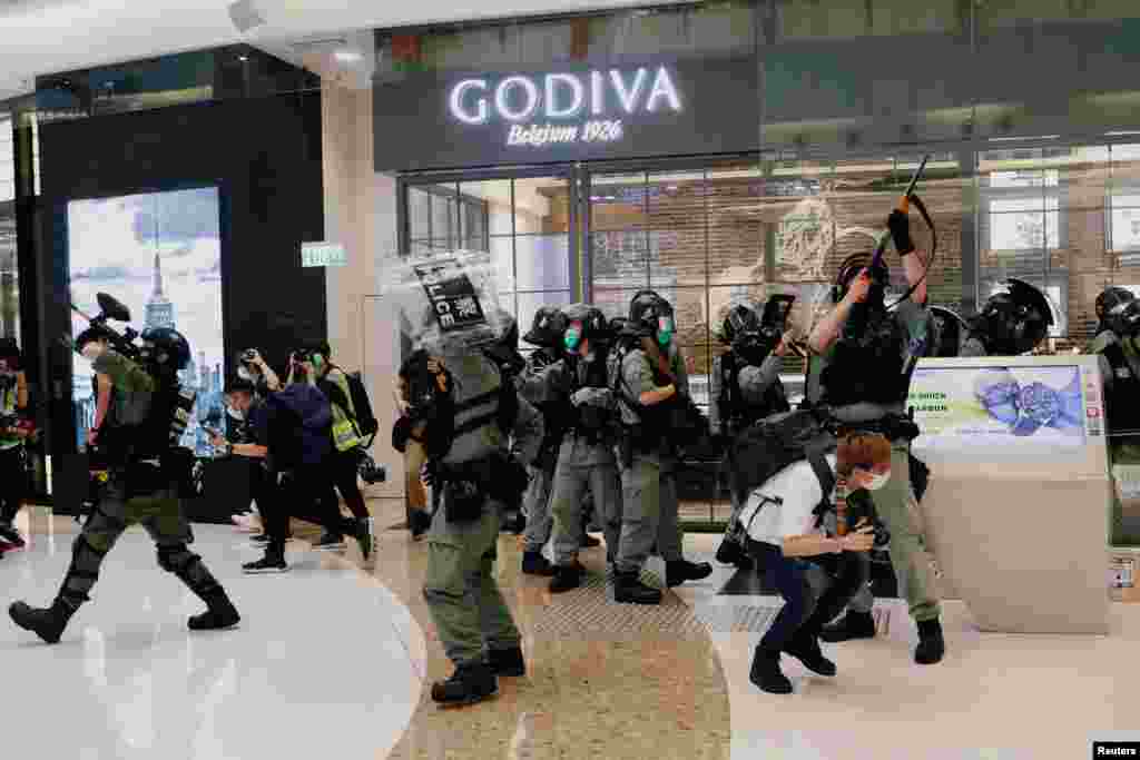 Riot police disperse anti-government protesters during a rally in a shopping mall in Hong Kong, China.