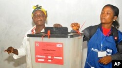 FILE - A woman cast her vote during a Presidential runoff election in Monrovia, Liberia, Tuesday, Dec. 26, 2017. 