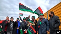 Libyans mark the 10th anniversary of their 2011 uprising that led to the overthrow and killing of longtime ruler Moammar Gadhafi, in Benghazi, Libya, Feb 17, 2021.