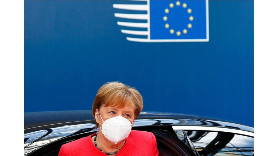 FILE - German Chancellor Angela Merkel wears a protective face mask as she arrives for the continuation of an EU summit meeting in Brussels, Belgium, July 20, 2020.