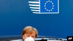 German Chancellor Angela Merkel wears a protective face mask as she arrives for the continuation of an EU summit meeting in Brussels, Belgium, July 20, 2020. 