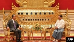 FILE - This photograph taken and released on Aug. 14, 2024, by the Myanmar Military Information Team shows Myanmar's military chief Min Aung Hlaing (R) meeting with China's Foreign Minister Wang Yi in Naypyidaw.