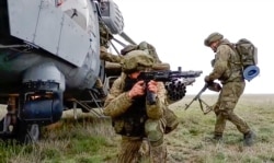 This handout photo taken from a video released on April 22, 2021 by Russian Defense Ministry Press Service, shows Russian troops take part in drills in Crimea.