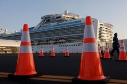 A security guard stands near the quarantined Diamond Princess cruise ship in Yokohama, near Tokyo, Feb. 13, 2020.