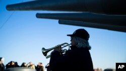 Bugler Nan LaCorte play taps during a ceremony commemorating the anniversary of the Dec. 7, 1941 Japanese attack on Pearl Harbor, on board The Battleship New Jersey Museum and Memorial in Camden, N.J., Thursday, Dec. 7, 2017.