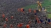 In this photo released by Xinhua News Agency, rescuers search for victims in the aftermath of a landslide in Junlian county near the city of Yibin in southwestern China's Sichuan Province, Feb. 9, 2025. 