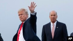 FILE - President Donald Trump is joined by Gordon Sondland, the U.S. ambassador to the European Union, second from right, as he arrives at Melsbroek Air Base, in Brussels, Belgium. 