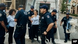 Police arrest activists after they blocked Fifth Avenue during a protest against President Donald Trump's immigration policies in New York, Sept. 5, 2017. 