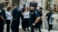 Police arrest activists after they blocked Fifth Avenue during a protest against President Donald Trump's immigration policies in New York, Sept. 5, 2017. 