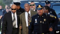 Actor and comedian Bill Cosby, center, arrives for a court appearance Tuesday, Feb. 2, 2016, in Norristown, Pa. Cosby was arrested and charged with drugging and sexually assaulting a woman at his home in January 2004.