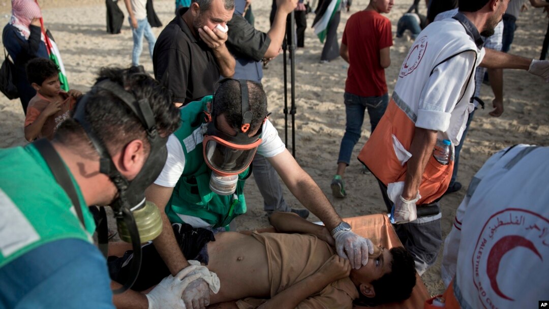 Palestinian medics evacuate a wounded youth who was shot by Israeli troops during a protest on the beach at the border with Israel near Beit Lahiya, northern Gaza Strip, Oct. 22, 2018. Another youth was fatally shot Oct. 23 during a protest along the perimeter fence with Israel, Gaza's Health Ministry said.