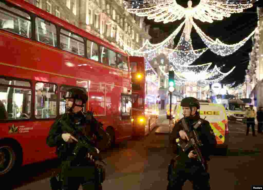 Armed police officers stand on Oxford Street, London, Britain, Nov. 24, 2017. 