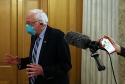 U.S. Senator Bernie Sanders (I-VT) speaks to reporters while leaving the Senate floor on Capitol Hill in Washington, Dec. 30, 2020.