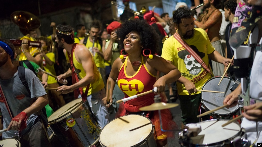A woman sporting a Chapulin Colorado costume, from the Mexican television series, drums during the "Chroma Aqui na Minha Mao" street party in Rio de Janeiro, Brazil, Feb 8, 2018.