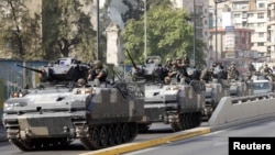 Lebanese army convoy secures portions of Beirut after a night of violent clashes, October 22, 2012.