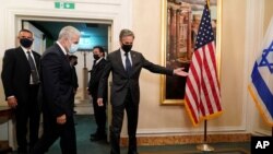 U.S. Secretary of State Antony Blinken, right, welcomes Israeli Foreign Minister Yair Lapid to their meeting in Rome, Italy, June 27, 2021. 