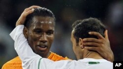 Ivory Coast's Didier Drogba, left, greets Portugal's Ricardo Carvalho at the end of  the World Cup group G soccer match between Ivory Coast and Portugal at Nelson Mandela Bay Stadium in Port Elizabeth, South Africa, Tuesday, June 15, 2010. The game ended 