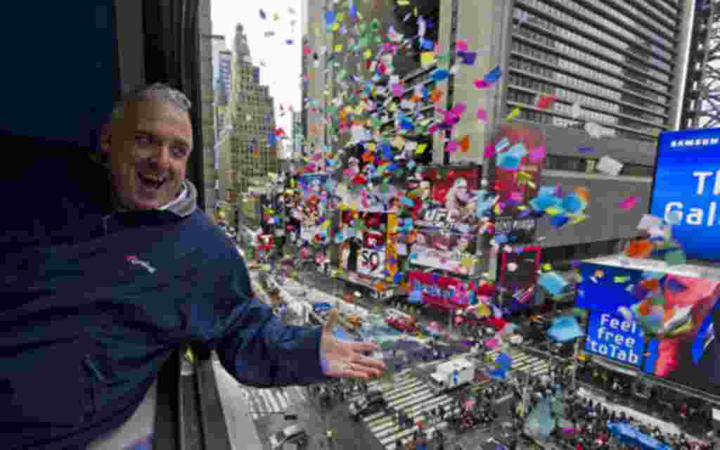 John Heald tests confetti that will be used in the New Year's celebration from a window above Times Square