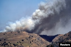 Smoke rises amid ongoing cross-border hostilities between Hezbollah and Israeli forces, in the Israeli-occupied Golan Heights, on June 13, 2024.